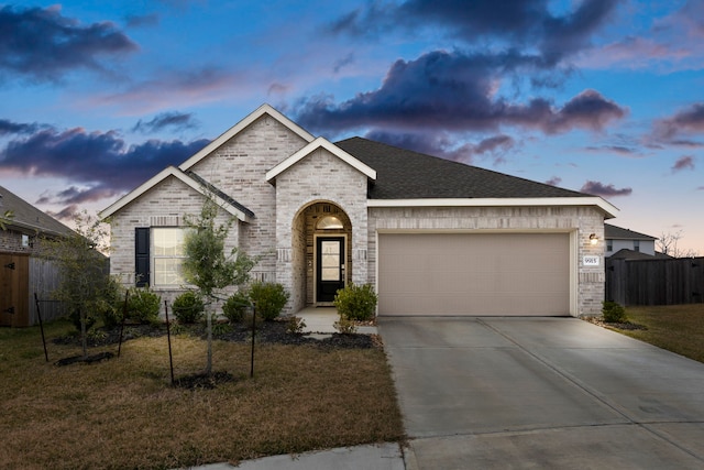 view of front facade with a garage and a lawn