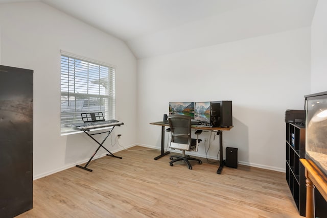 office space with lofted ceiling and light hardwood / wood-style flooring