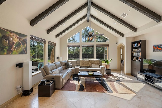 living room with beamed ceiling, light tile patterned flooring, a wealth of natural light, and ceiling fan