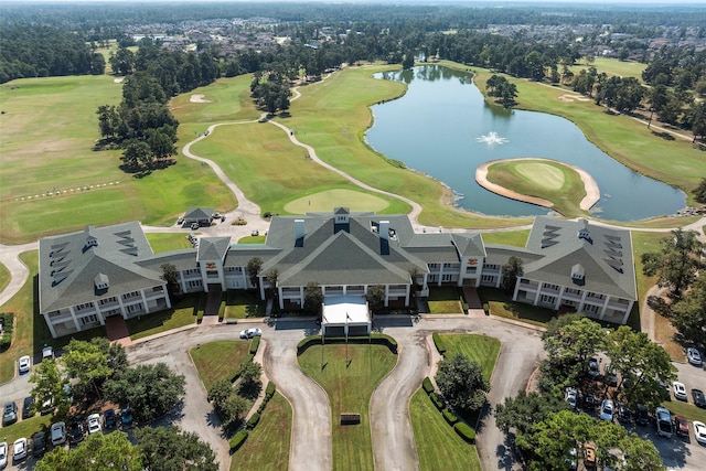 drone / aerial view with golf course view and a water view