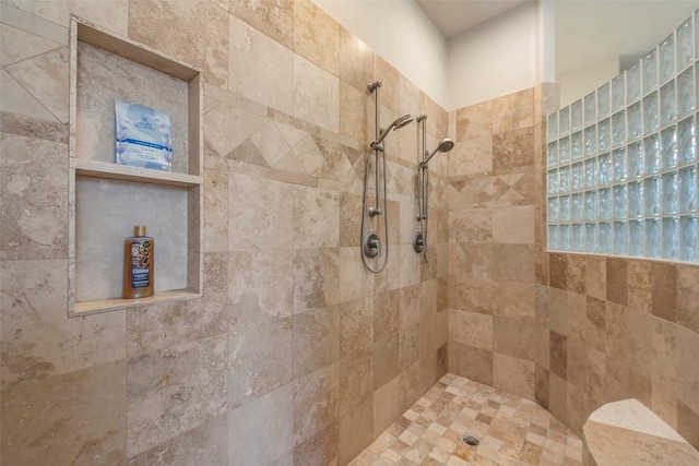 bathroom with a tile shower