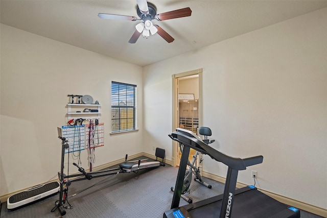 workout room featuring a ceiling fan and baseboards