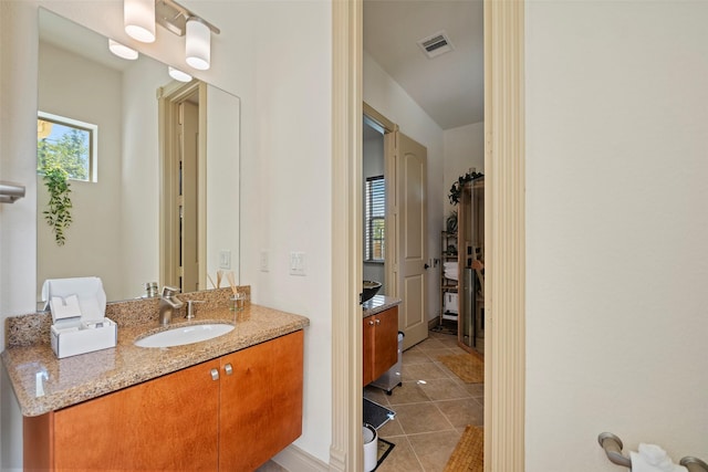 bathroom with visible vents, vanity, and tile patterned floors