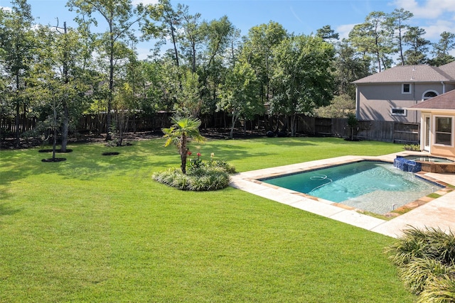 view of pool with a yard, a fenced backyard, and a pool with connected hot tub