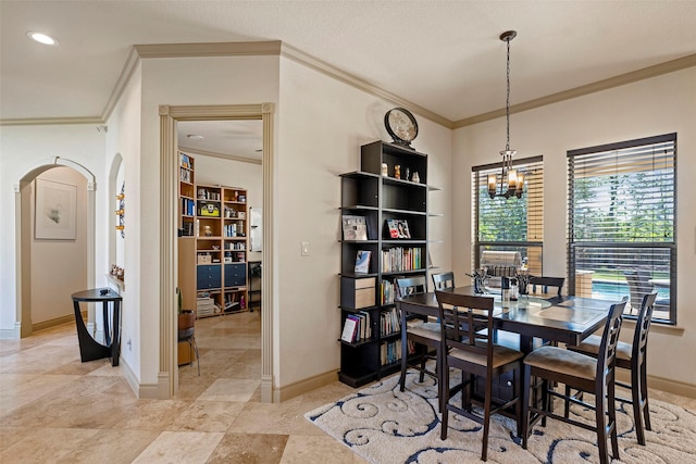 dining space with arched walkways, crown molding, recessed lighting, an inviting chandelier, and baseboards