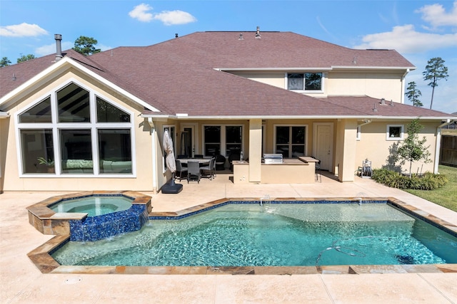 rear view of property with a patio area, a shingled roof, a pool with connected hot tub, and stucco siding