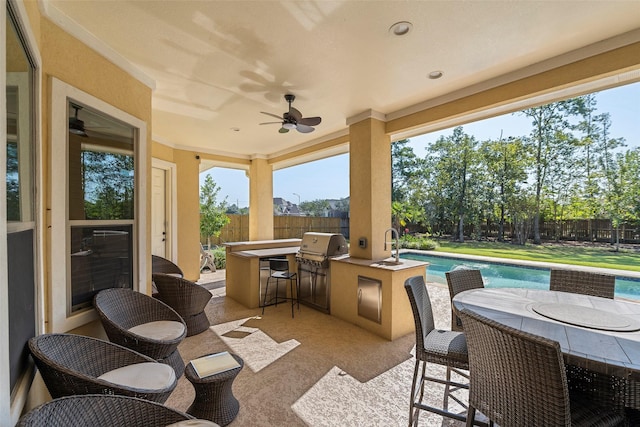 view of patio featuring a fenced backyard, area for grilling, a ceiling fan, outdoor dry bar, and a fenced in pool