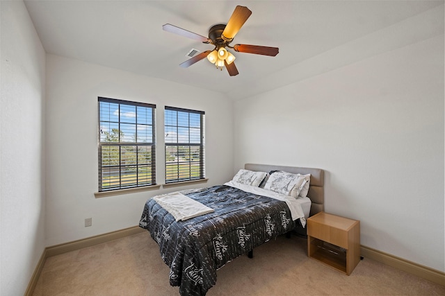 bedroom with carpet floors, a ceiling fan, visible vents, vaulted ceiling, and baseboards