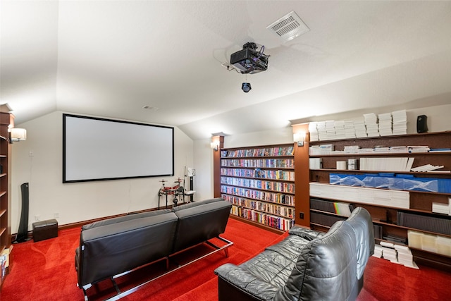 carpeted cinema featuring lofted ceiling and visible vents