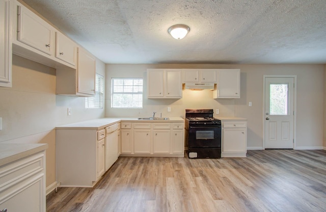 kitchen featuring black range with gas cooktop, light hardwood / wood-style floors, dishwasher, white cabinets, and sink