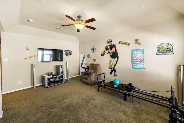 exercise area featuring ceiling fan, dark colored carpet, and lofted ceiling