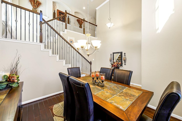 dining room with a chandelier, a high ceiling, and dark hardwood / wood-style flooring