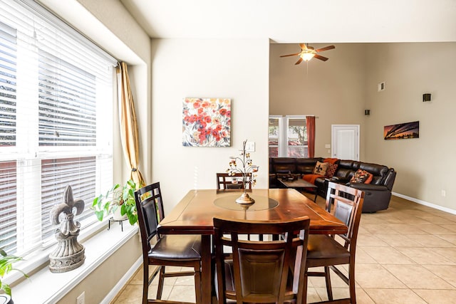 tiled dining space with ceiling fan