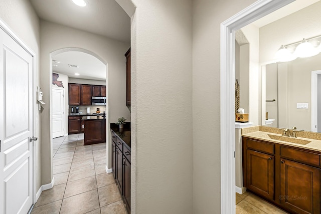 interior space with sink and light tile patterned flooring