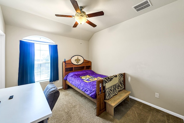 carpeted bedroom featuring ceiling fan, multiple windows, and vaulted ceiling