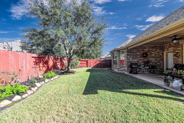 view of yard with a patio and ceiling fan