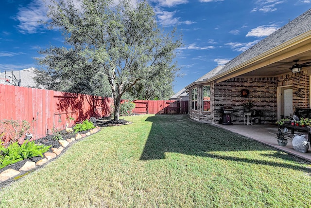 view of yard featuring a patio area, a fenced backyard, and a ceiling fan