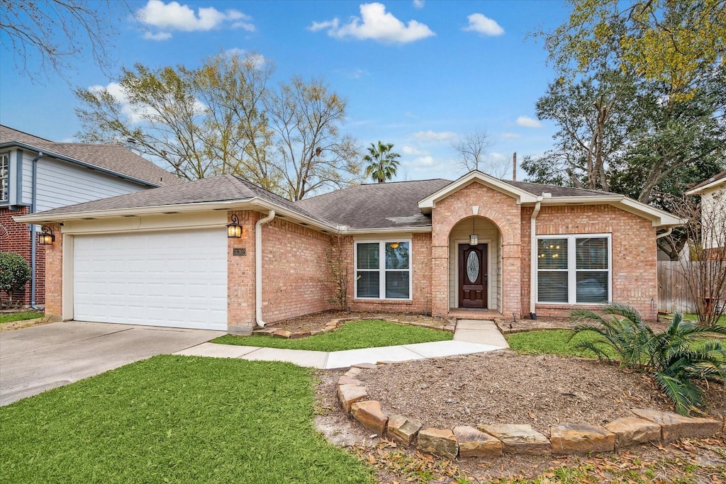 ranch-style home with a garage and a front lawn