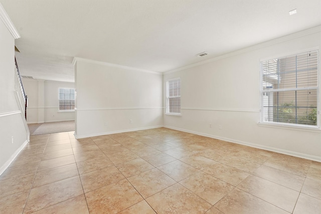 unfurnished room featuring ornamental molding and light tile patterned floors