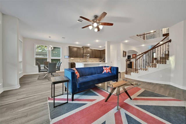 living room with ceiling fan and light hardwood / wood-style floors