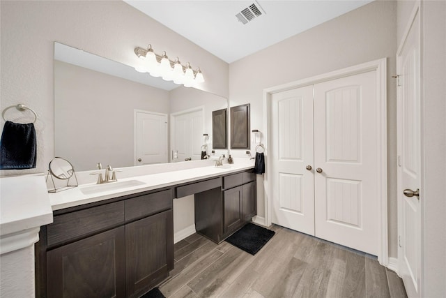 bathroom with hardwood / wood-style flooring and vanity