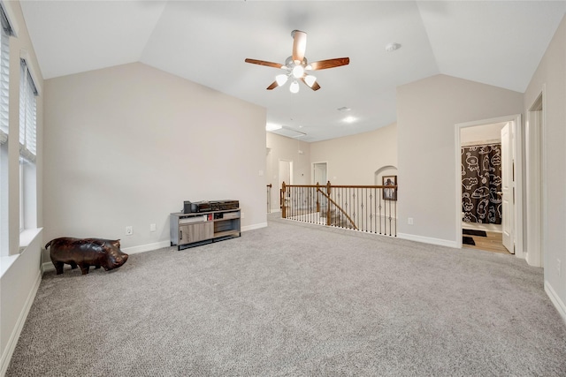 interior space featuring carpet floors, lofted ceiling, and ceiling fan