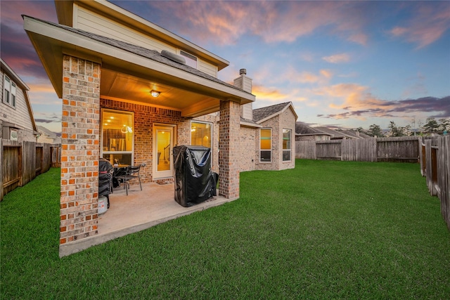 exterior space with a lawn and a patio