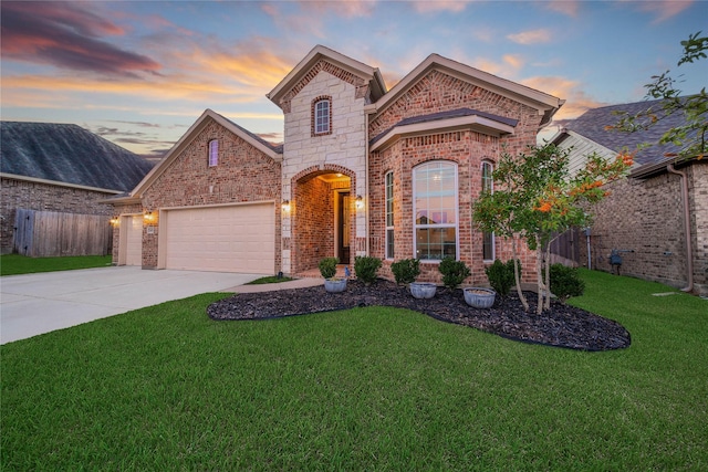 view of front of house featuring a lawn and a garage