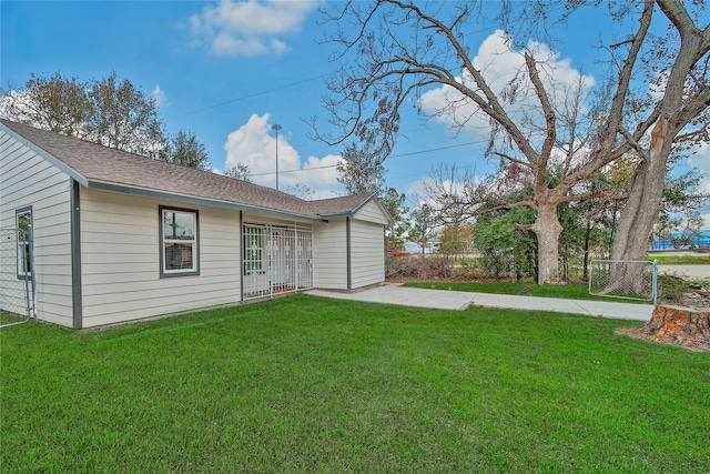 rear view of property featuring a lawn