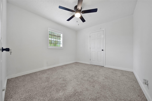 empty room featuring carpet floors and ceiling fan