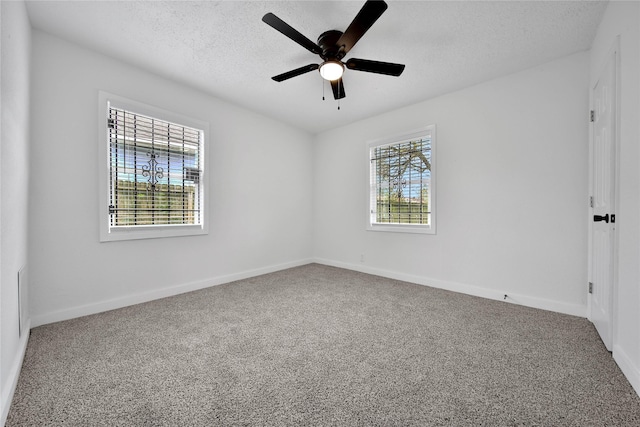 empty room featuring carpet floors, a textured ceiling, and ceiling fan