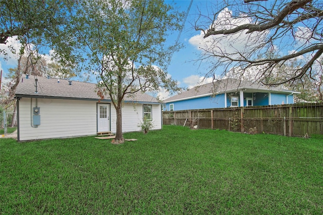 back of house with a yard