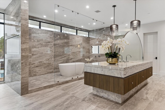 bathroom featuring independent shower and bath, tile walls, and vanity