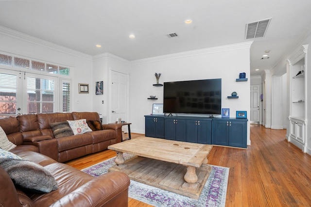 living room with light wood-type flooring and ornamental molding