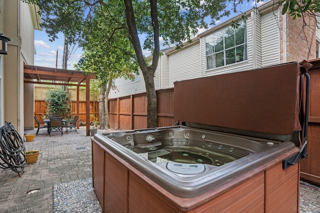 view of patio featuring a hot tub and a pergola