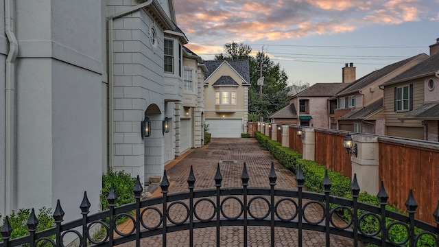 gate at dusk with a garage