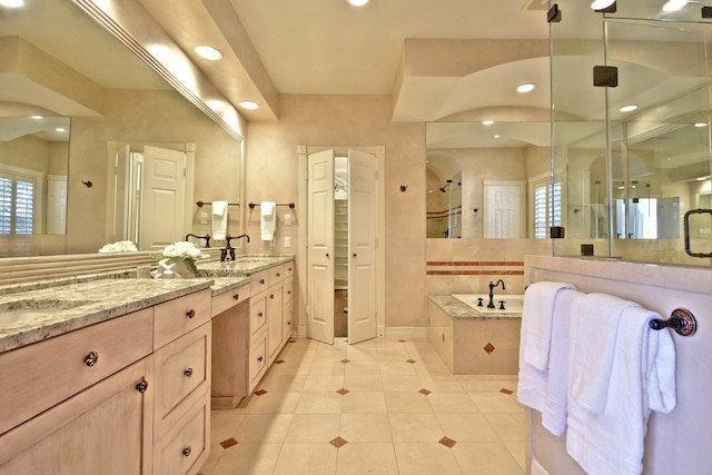 bathroom featuring vanity, shower with separate bathtub, and tile patterned flooring