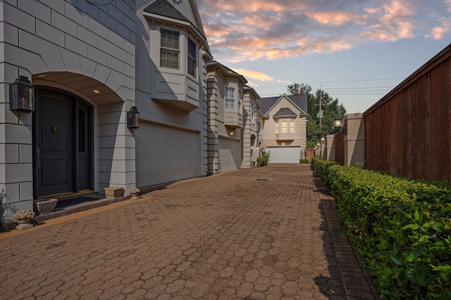 property exterior at dusk with a garage