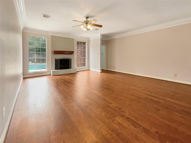 unfurnished living room with ceiling fan, hardwood / wood-style flooring, ornamental molding, and a fireplace