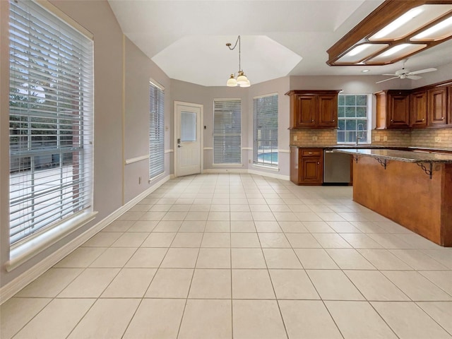 18418 Forest Elms Dr, Spring, TX 77388 - kitchen with a breakfast bar, dishwasher, light tile patterned floors, backsplash, and pendant lighting