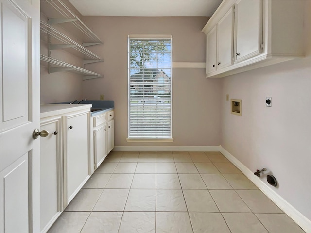 18418 Forest Elms Dr, Spring, TX 77388 - laundry room featuring cabinet space, washer hookup, baseboards, light tile patterned floors, and hookup for an electric dryer