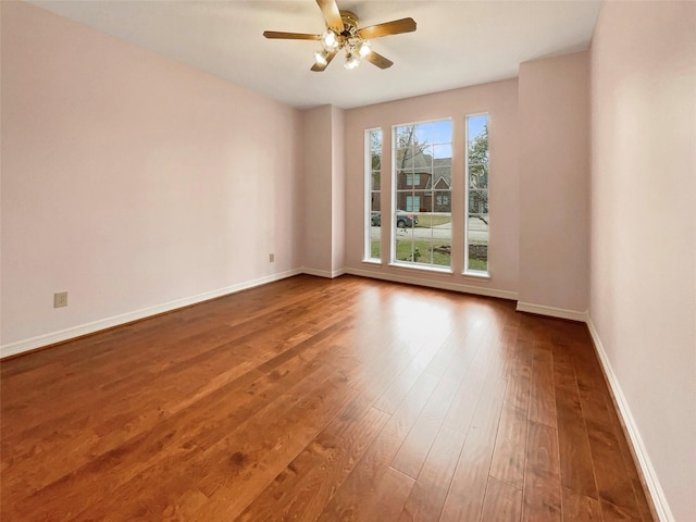 spare room with ceiling fan and wood-type flooring