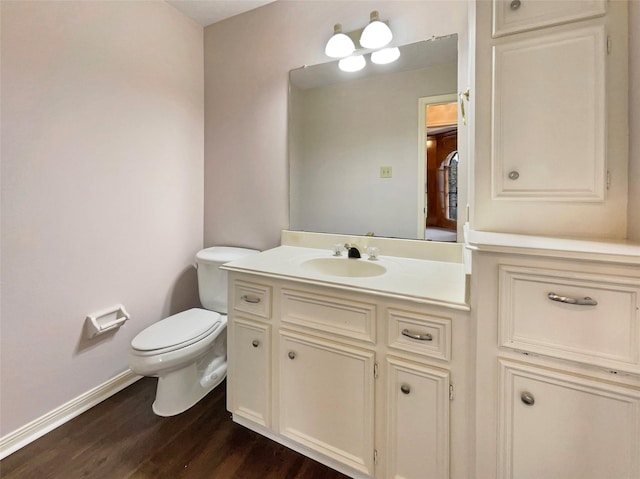 18418 Forest Elms Dr, Spring, TX 77388 - half bathroom with toilet, baseboards, wood finished floors, and vanity
