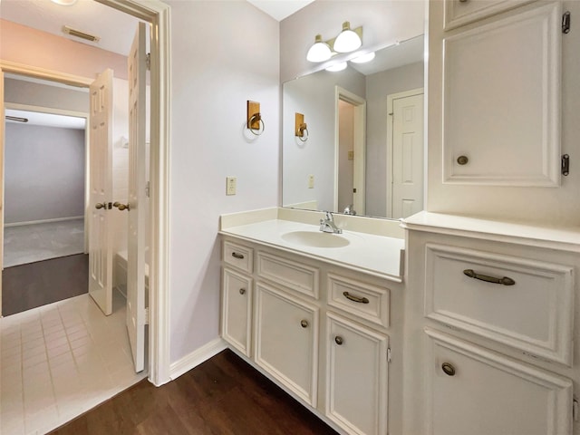 bathroom with vanity and hardwood / wood-style flooring