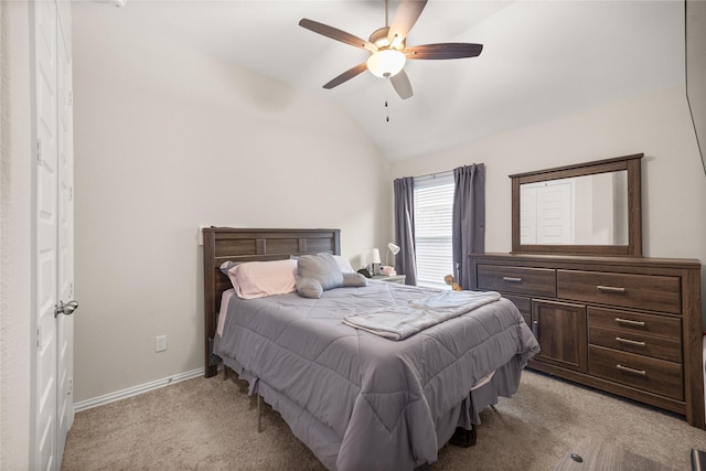 bedroom with ceiling fan, lofted ceiling, and light colored carpet