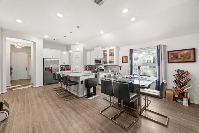 dining room featuring sink and light hardwood / wood-style floors