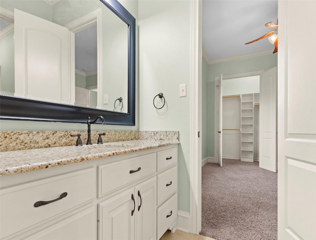 bathroom with vanity, ceiling fan, and ornamental molding