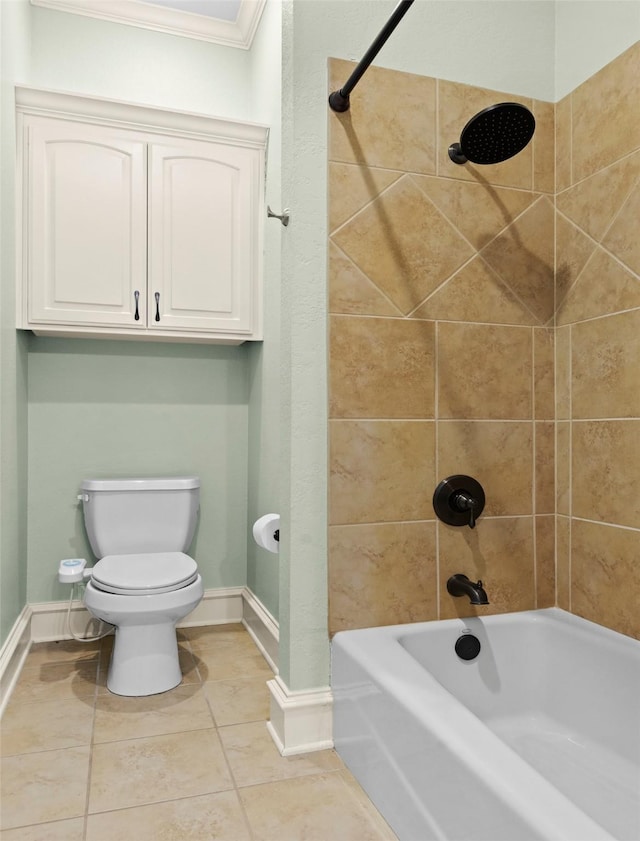 bathroom with toilet, crown molding, tile patterned flooring, and tiled shower / bath combo