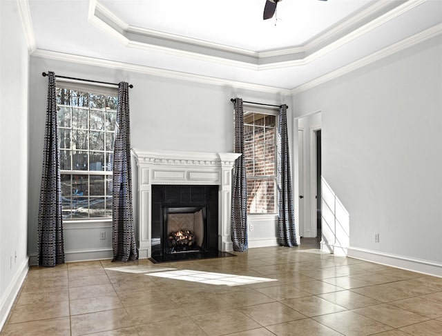 unfurnished living room featuring ornamental molding, a raised ceiling, tile patterned floors, and a tile fireplace