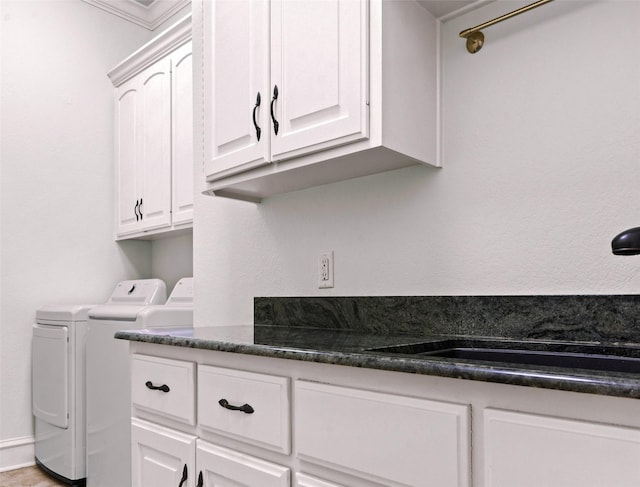 laundry room featuring sink, cabinets, and washer and clothes dryer